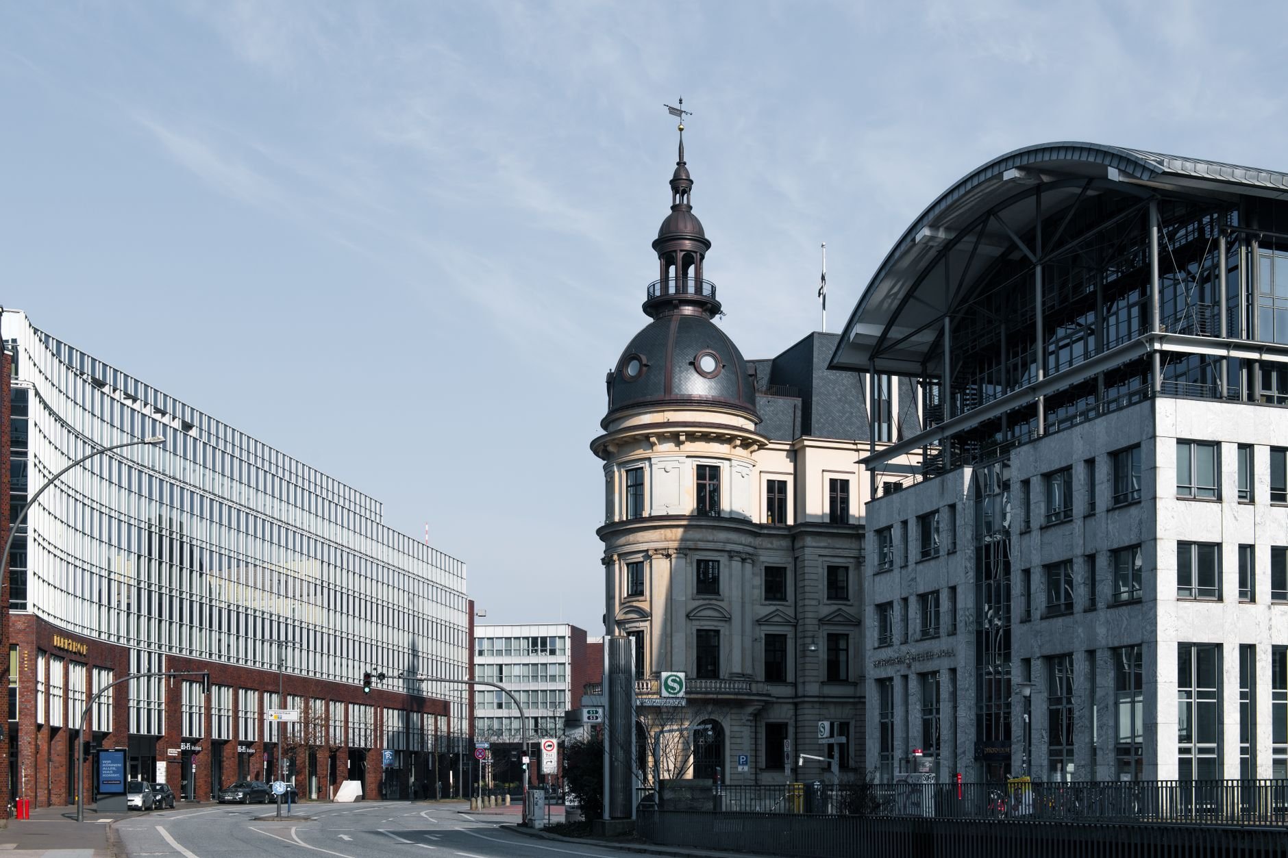 European cityscape with a blend of historic and modern architecture under a bright sky.